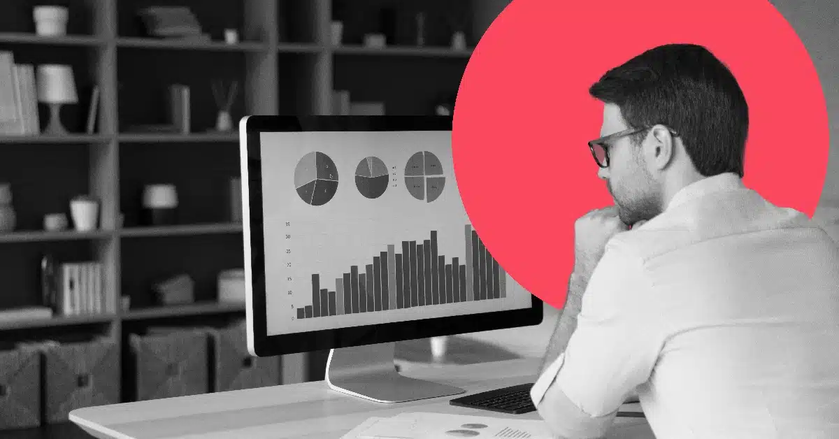 Man looking at pie charts and bar graphs on his computer monitor.