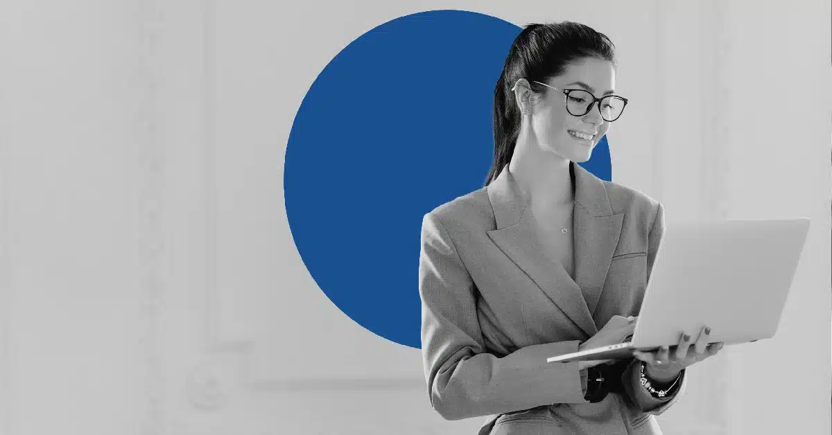 Smiling business woman looking at a laptop.