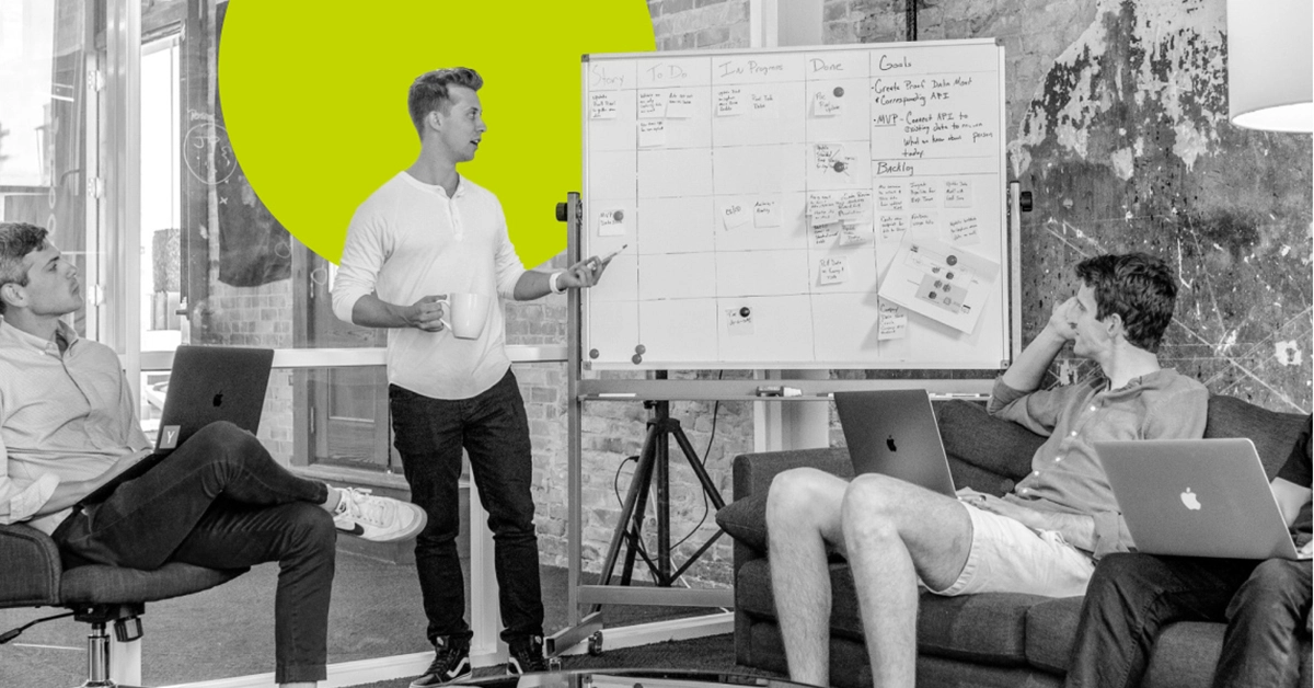 Content team figuring out their editorial calendar on a whiteboard.