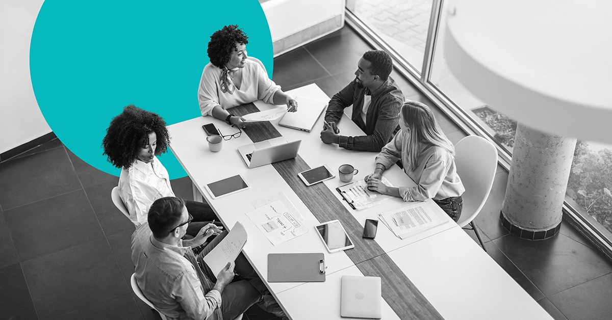 Marketers discussing the benefits of marketing automation in a meeting.