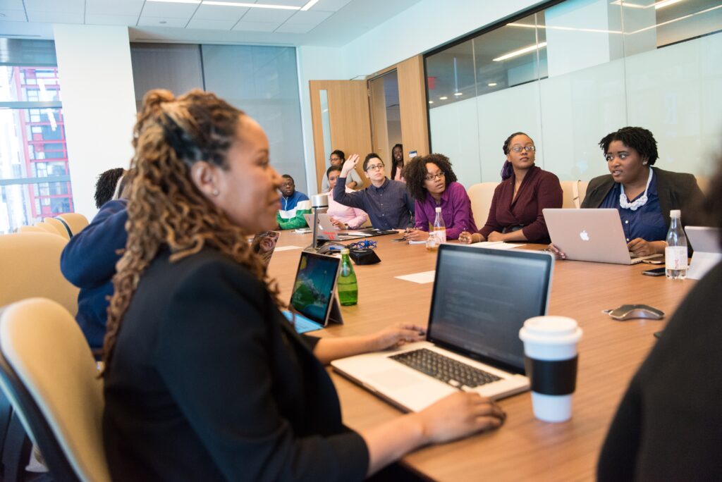 A diverse group of business leaders meet in a conference room to illustrate the concept of account-based marketing best practices