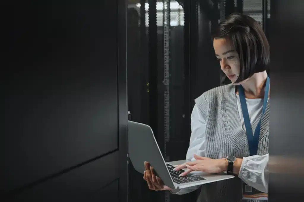 a woman in a data center reading up on email marketing laws for 2024.