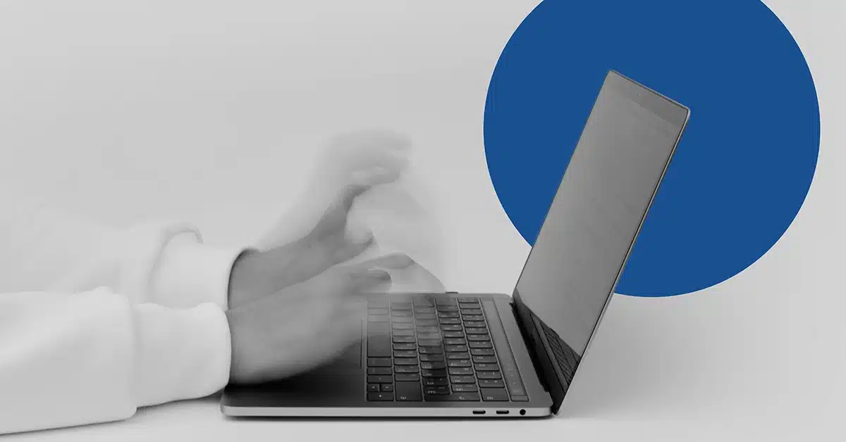 Closeup of hands typing on a keyboard.