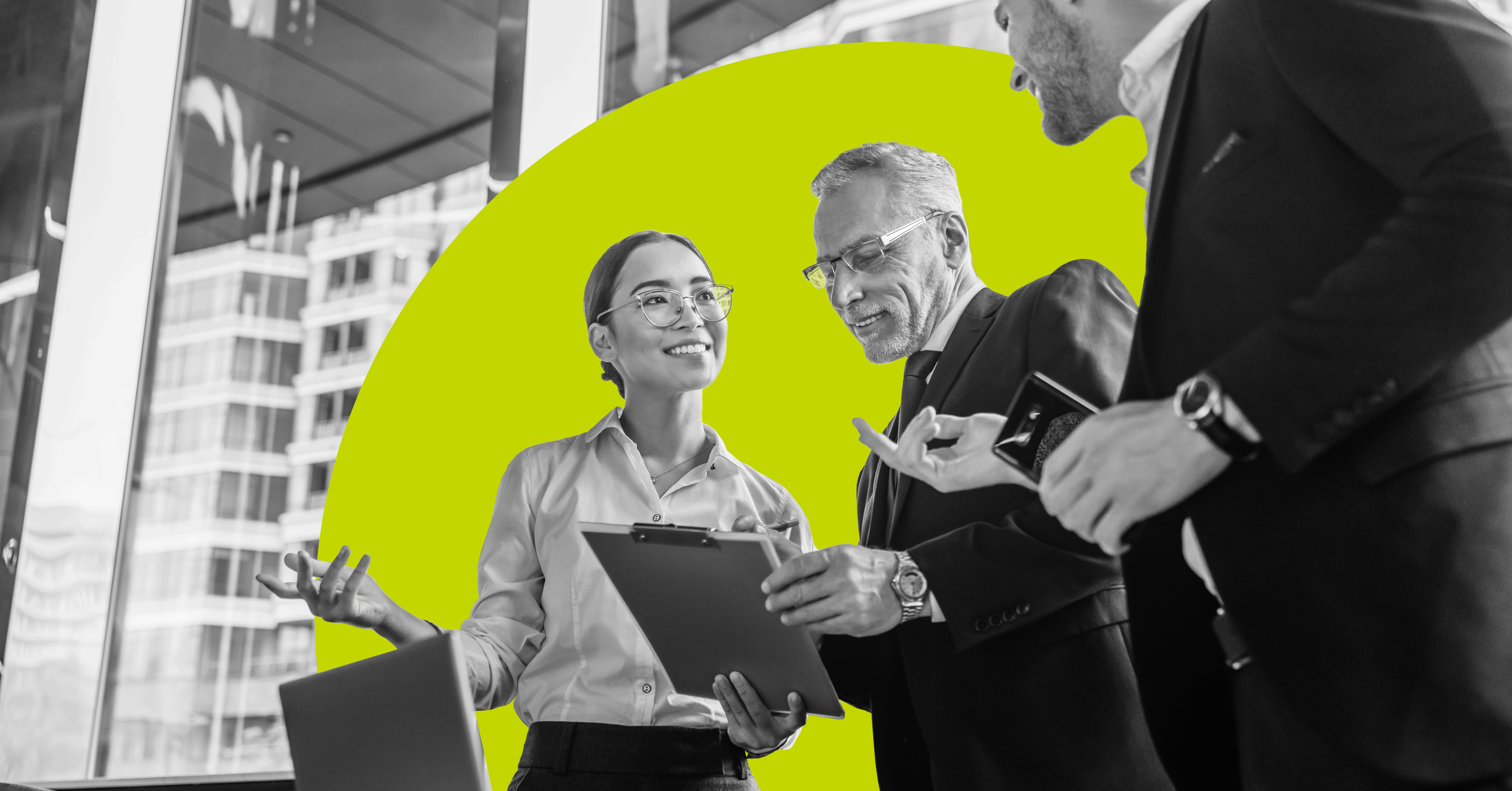 a group of professionals stand at a desk and collaborate