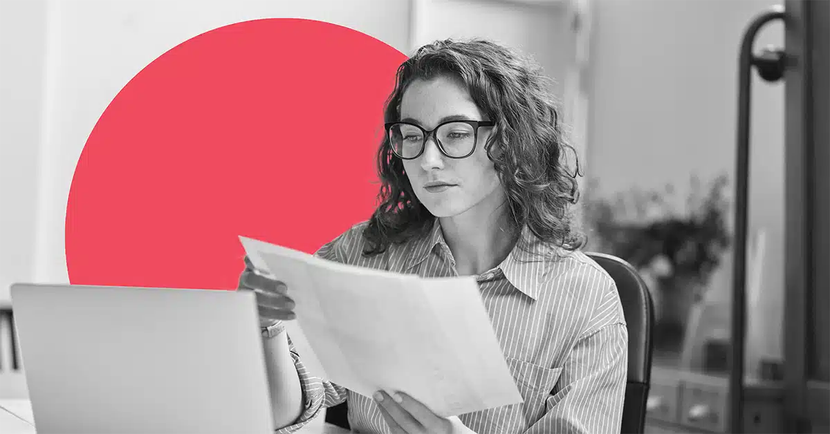 a woman reviews important documents at her laptop to illustrate how to turn customers into brand advocates