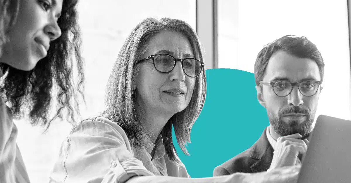 a diverse team collaborates at a computer screen on key brand elements