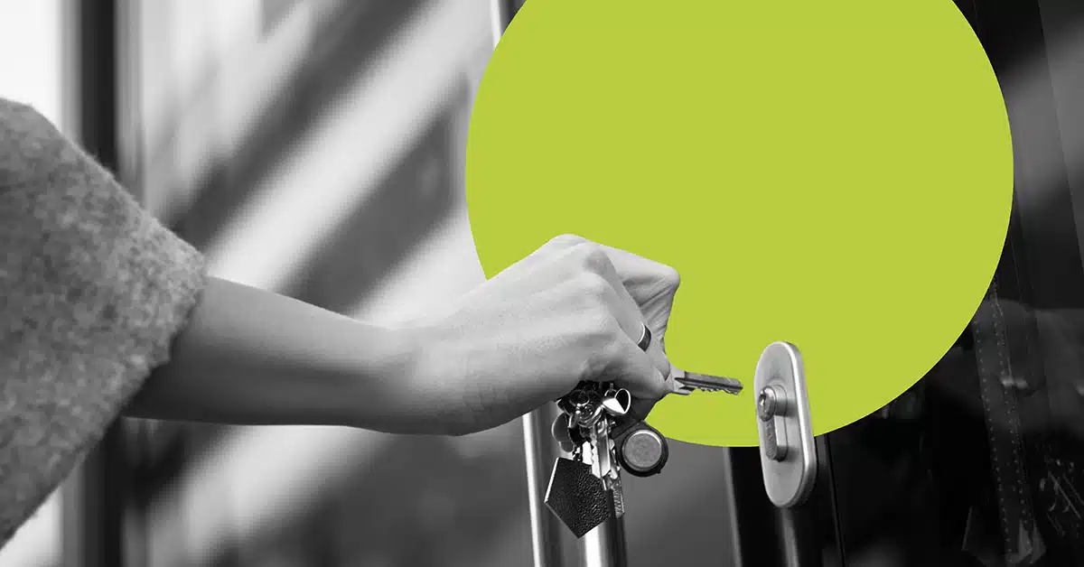 a hand uses keys to unlock a door