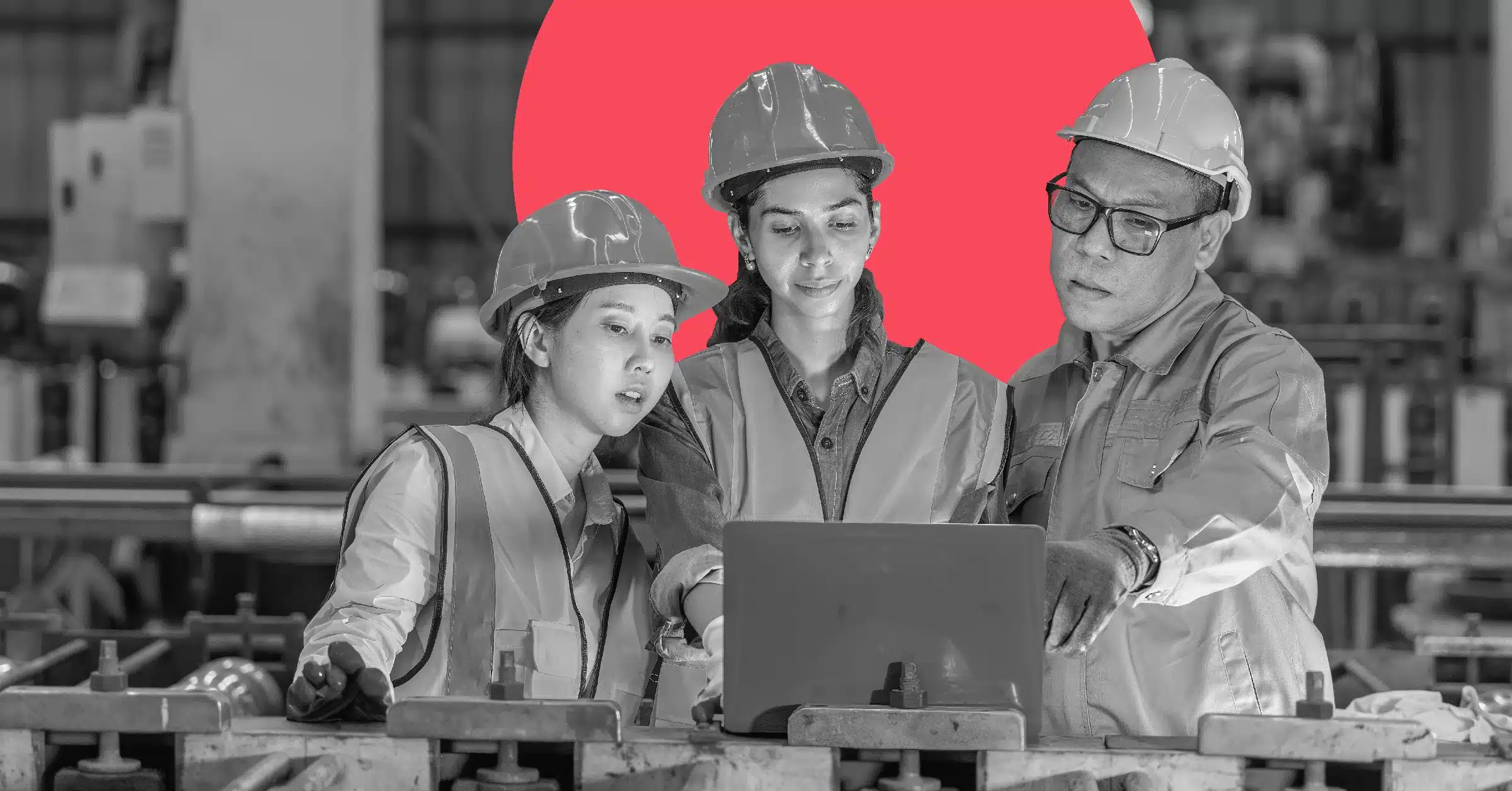 Colleagues discussing content marketing for manufacturers on a factory floor.