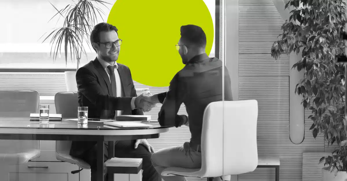 Ratail bank employee shaking hands with a customer.